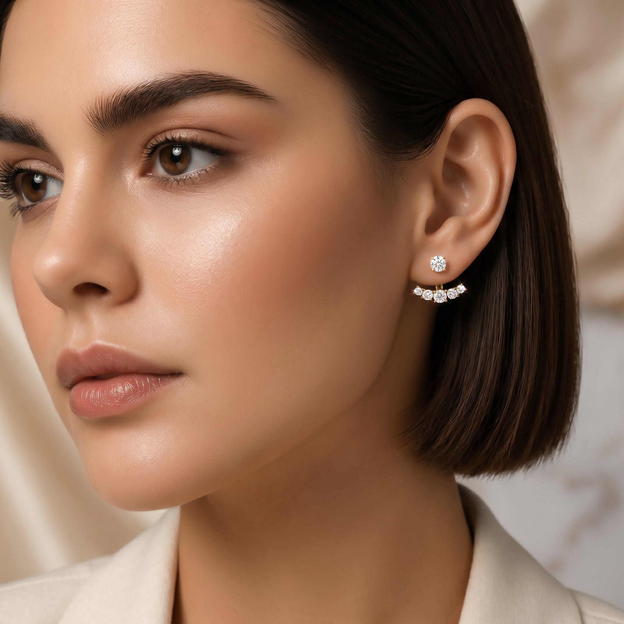 Detailed close-up of 14K gold diamond ear jacket earrings on a model emphasizing craftsmanship and sparkle.